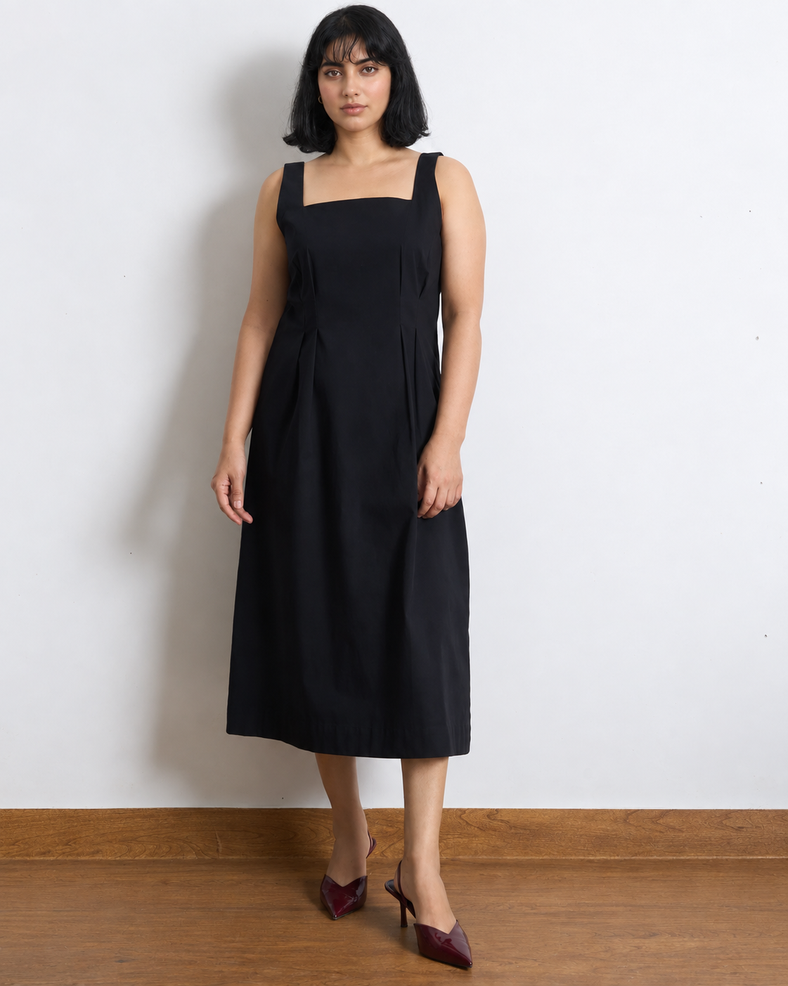 Classic Black Dress by Lõma — clean midi dress with structured square neckline in 100% cotton, front view